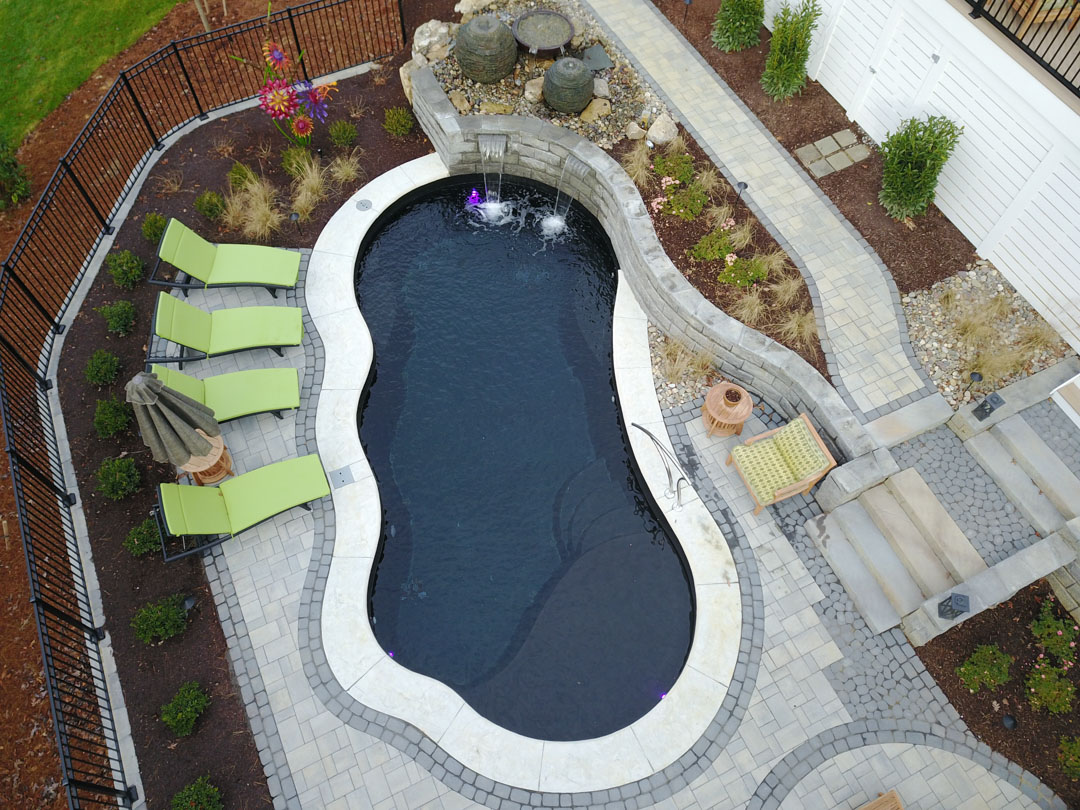 Luxury in ground fiberglass pool installation project by Superior Hardscapes