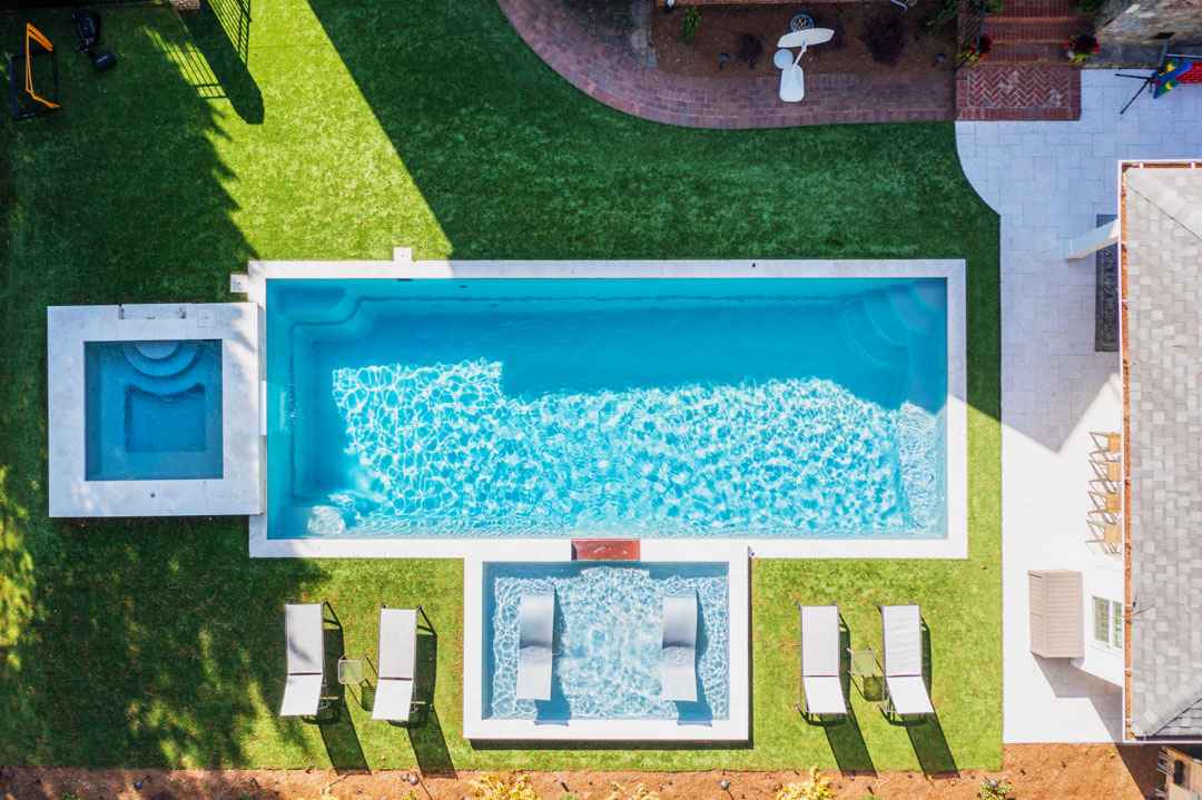 Image from a drone showing a fiberglass pool from the air